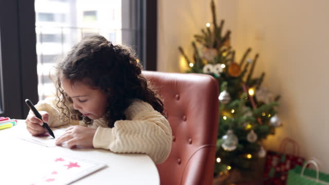 Little girl drawing Christmas cards