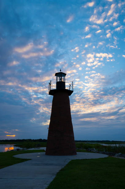 istock Light house at sunrise by lake 1415188647