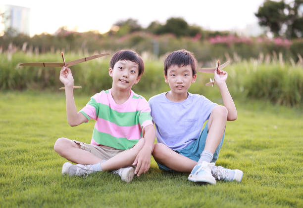 Boy hand holding a paper plane