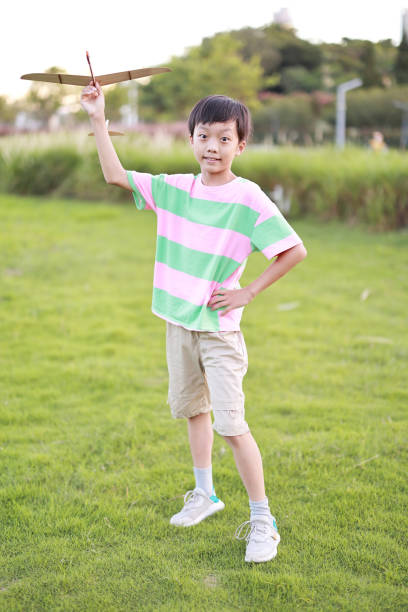 Boy hand holding a paper plane