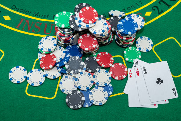 istock poker chips with playing cards scattered on a green casino table 1415192839