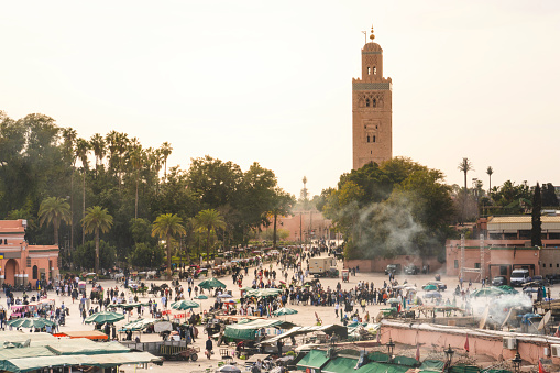 view of Koutoubia Mosque and Jamaa El Fna square crowded - Marrakech, Morocco