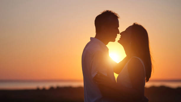 istock Husband expresses true love to gorgeous lover at back sunset 1415194353