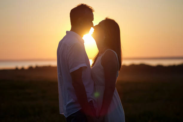 istock Husband expresses true love to gorgeous lover at back sunset 1415194367