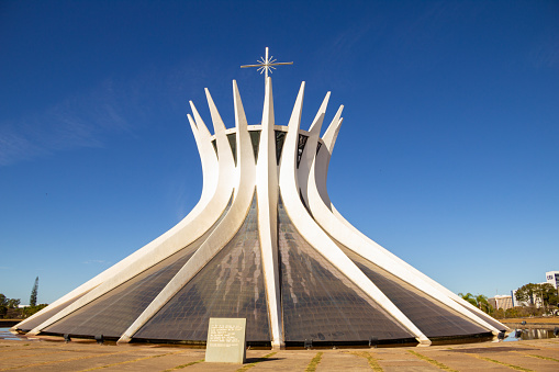 Brasília, Federal District, Brazil – July 24, 2022: Metropolitan Cathedral of Brasilia on a sunny morning and clear sky. (Our Lady of Aparecida Metropolitan Cathedral). The Cathedral is an architectural work by Oscar Niemeyer.
