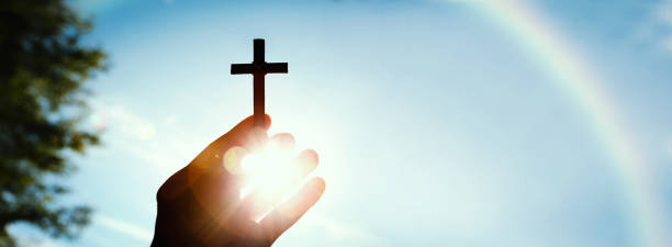 the cross of jesus christ shining in the sun and blue sky and rainbow - cross church white heaven imagens e fotografias de stock