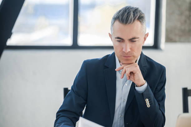 istock New idea. A businessman sitting in the office and thinking 1415196899