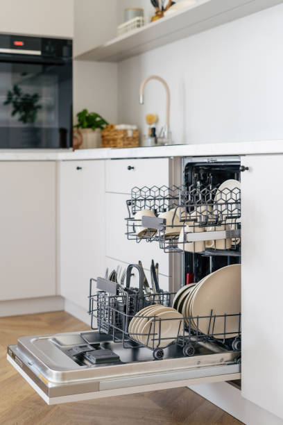 istock Open dishwasher with clean dishes in kitchen interior design 1415199761