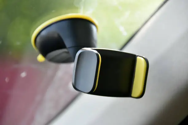 Photo of Mobile phone holder on the windshield of the car.