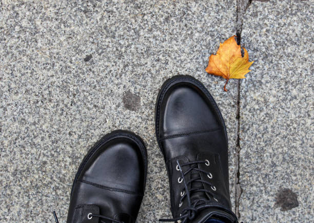 black leather boots with high heel.  Autumn street fashion look