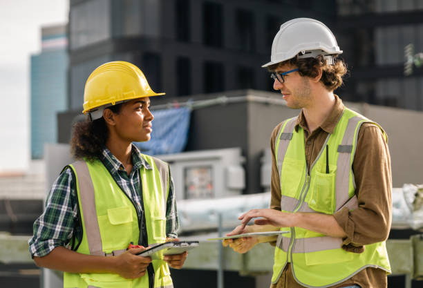 istock Two Professional engineer man and women working checking and maintenance pipeline construction top of the building. Worker in safety uniform using tablet at pipeline construction system 1415202080
