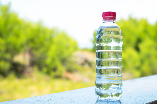 Water bottle with nice background. Plastic water bottle with green background.