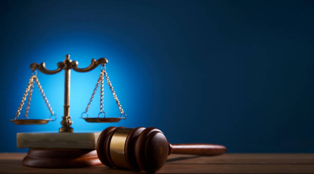 istock gavel hammer and balance scale against blue background 1415203216