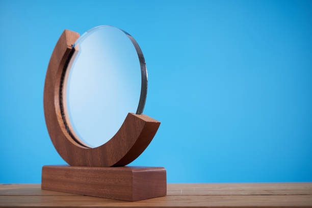 istock crystal trophy against blue background 1415203234