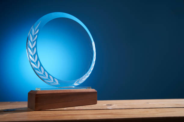 istock light on the crystal trophy against blue background 1415203312
