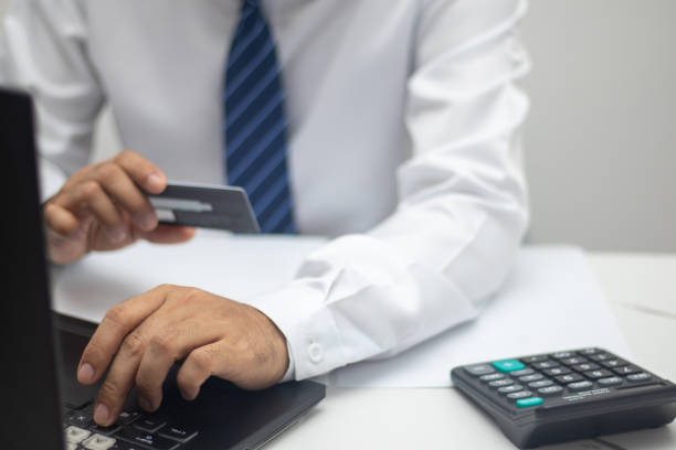 istock Businessman paying online via credit card 1415206437