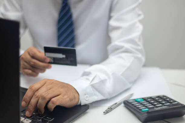 istock Businessman paying online via credit card 1415206443