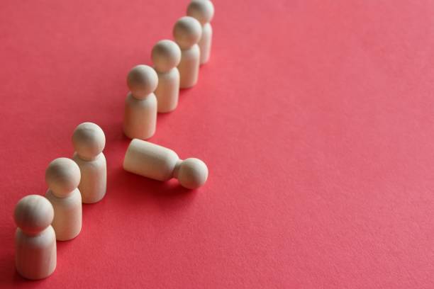 istock Wooden doll fall out of row line 1415206782