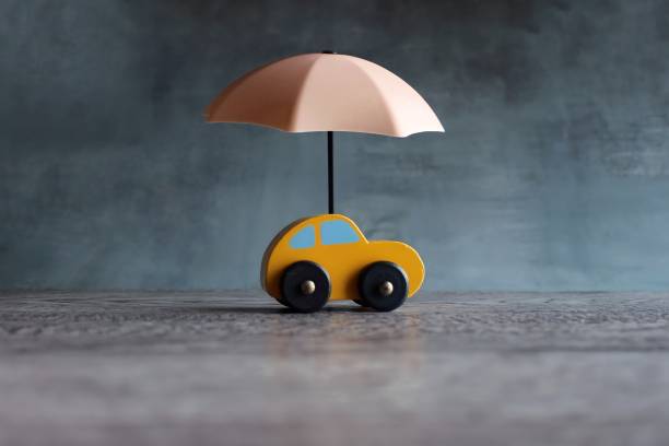 Car protection and insurance concept. Umbrella and toy car with copy space. Car protection and insurance concept. car insurance stock pictures, royalty-free photos & images
