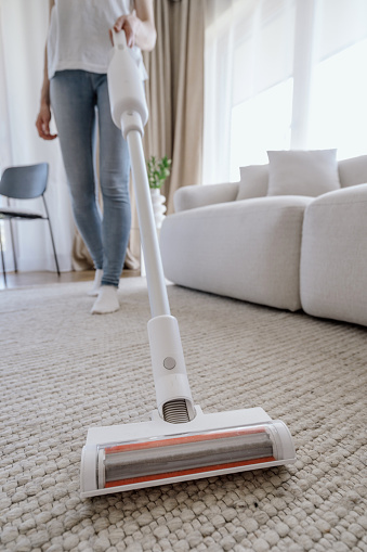Vacuum cleaner on the blue carpet floor