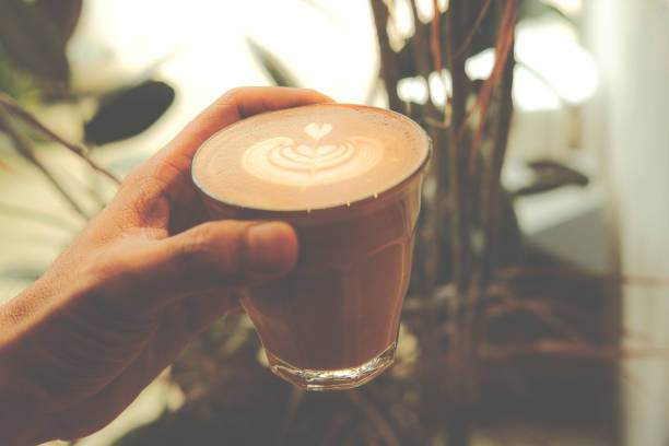 istock A cup of coffee latte top view with leaf shape foam 1415210037