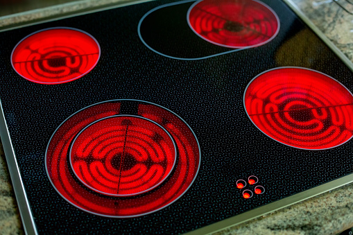 close-up of round red glowing induction stove