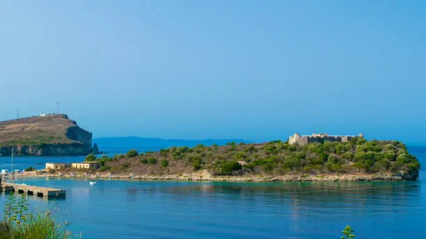 An old fortress Ali Pasha Tepelena Fortress Porto Palermo near Himare city located on a peninsula in the bay of the Ionian Sea. Albania. Blue summer landscape.