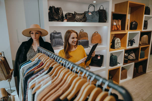 istock Woman using a digital tablet and taking inventory in a sustainable clothing store 1415212444