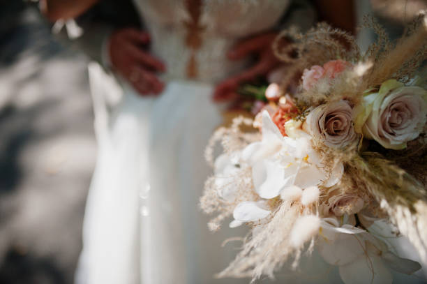 istock Bride and groom holding beautiful tender wedding bouquet. 1415212791
