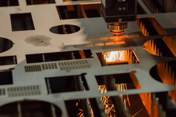 istock Laser cutting machine working with sheet metal with sparks 1415214089