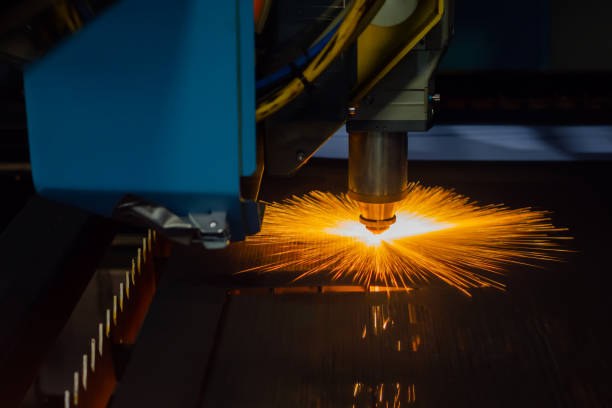 istock CNC laser cutting machine working with sheet metal with sparks 1415214094
