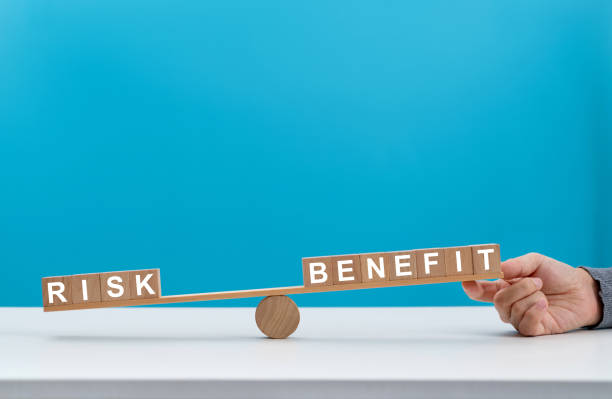 istock Wooden seesaw with word risk and benefit 1415217188