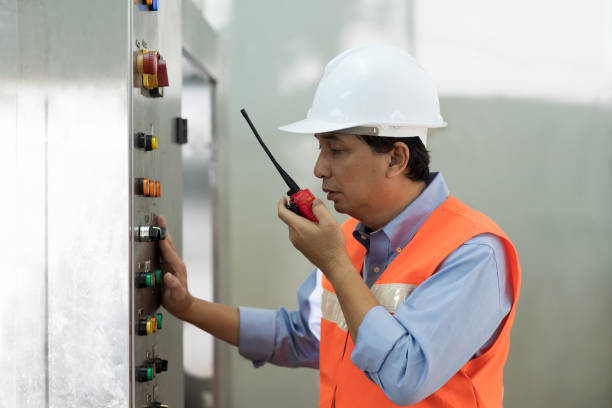 istock Electrical male engineer or electronic male technician maintenance electric system in the industry factory. Asian electrical male engineer worker checking  electric system with radio communication 1415217299