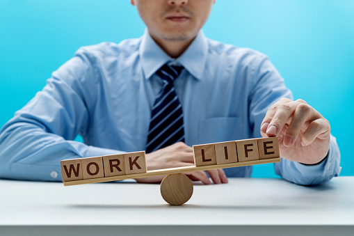 Wooden seesaw with word life and work.