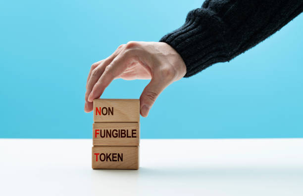 istock Human hand stacking text non-fungible token 1415217442