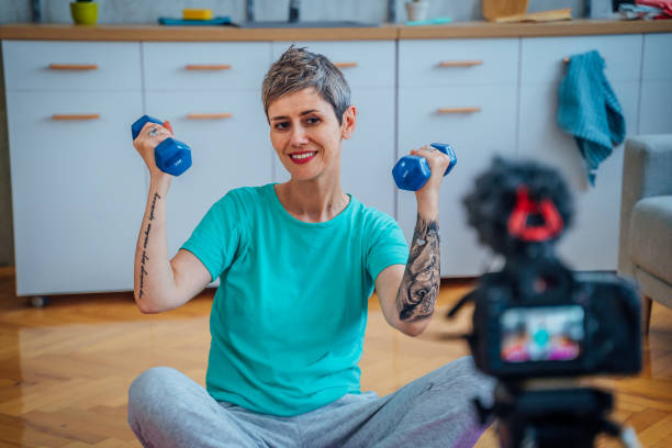 istock Woman live streaming about exercising 1415218034