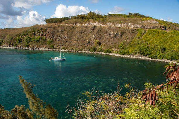 istock Blue sail boat in a cove 1415219144