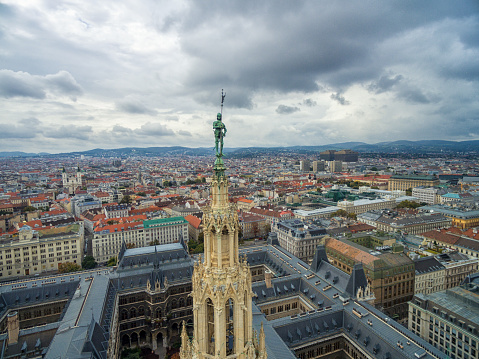 Vienna, Austria - October 10, 2016: Rathaus Roof with Statue. Vienna, Austria. Vienna Cityscape in Background.