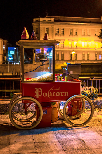 Old fashioned popcorn machine on the promenade in the evening