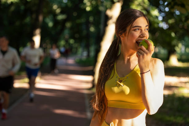 istock A fitness woman eats a green apple, after completing a training session. 1415220164