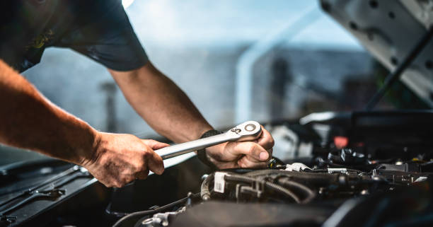 istock Auto mechanic working in garage. Repair service. 1415220186