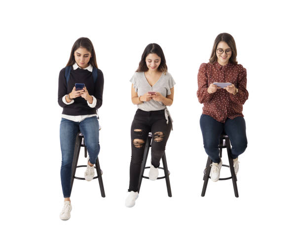 istock Three female students  sitting and using phones 1415221252
