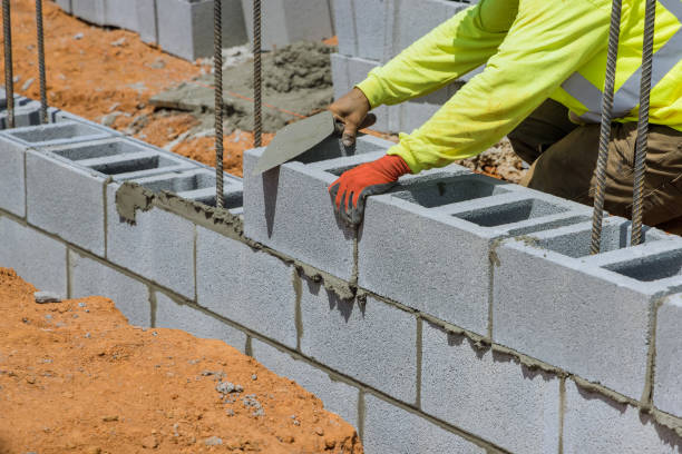 istock This mason installing a wall of aerated concrete blocks around him 1415221383