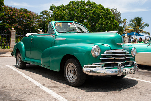 Havana, Cuba - August 3, 2022: Vintage taxi waiting for clients on hot summer day in Havana, capital city of Cuba