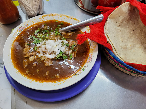 Overhead shot of a birria and handmade tortillas in the market, Mexico