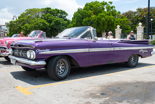 Havana, Cuba - August 3, 2022: Vintage taxi waiting for clients on hot summer day in Havana, capital city of Cuba