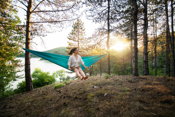 istock Swinging in a hammock and enjoying the view on sunset. 1415224992