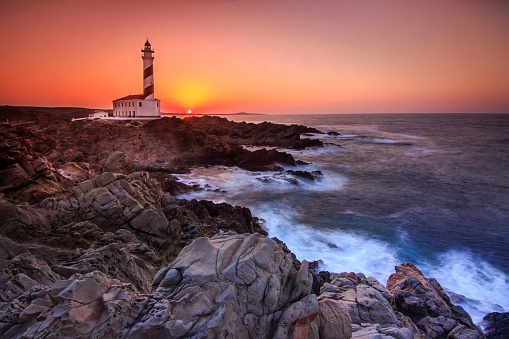 Lighthouse on the sea in a rain and storm.