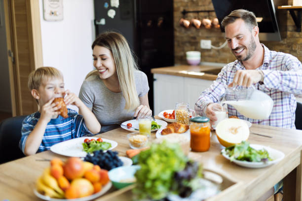 istock Happy family  talking during breakfast time at dining table 1415228483