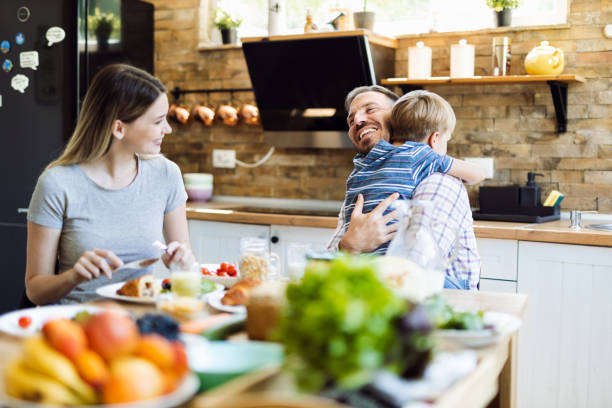 istock Happy family  talking during lunch time at dining table 1415228530